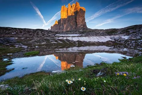 Reflection of Tre Cime di Lavaredo in a lake, Veneto, Italy Stock Photos