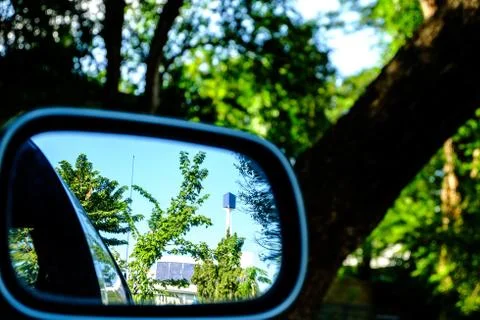 Reflection of trees and buildings. through the rear view mirror Stock Photos