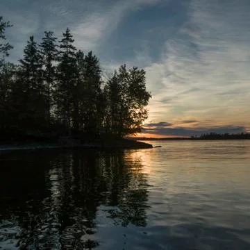 Reflection of trees and clouds in the lake, Lake of The Woods, Ontario, Canada Stock Photos