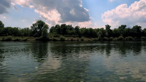 Reflection of trees and clouds in water Stock Footage 240255078