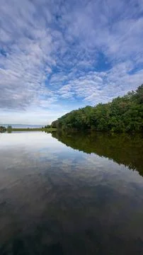 Reflection of Trees in a Calm Lake Stock Photos