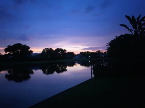 Reflection of tropical sunset Stock Photos