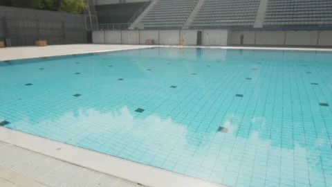Reflection of the turquoise water of a large Olympic pool, in Barcelona, Spain Stock Footage 221118766