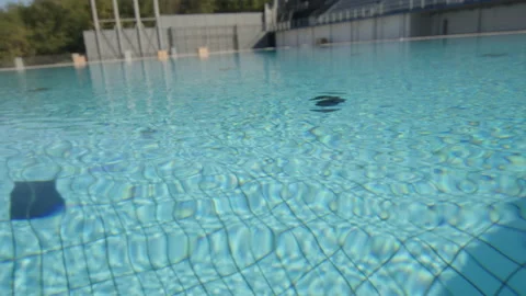 Reflection of the turquoise water of an Olympic pool, in Barcelona, Spain Stock Footage 221115153