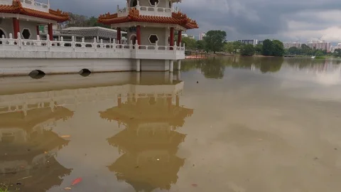 Reflection Of Twin Pagoda With Storm Clouds Passing Overhead. Pan Up Stock-Footage 106355216