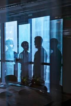 Reflection of two businessmen talking in the office Stock Photos