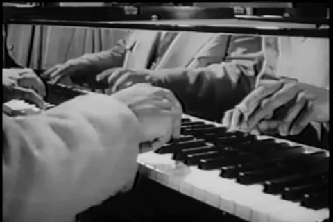 Reflection of two men playing a jazz duet on piano, 1950s 스톡 동영상 90762260