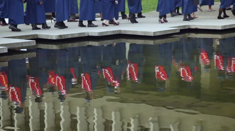 Reflection of University graduates in a pond. Stock Footage 45499498