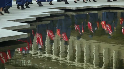 Reflection of University graduates in a pond. Stock Footage 45499576