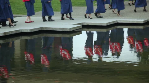 Reflection of University graduates in a pond. Stock Footage 45499646
