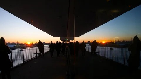 Reflection of unrecognizable people silhouettes sunset Elbphilharmonie Stock Footage 114283030