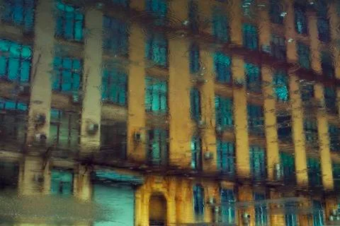 Reflection of urban building in a puddle Fotos de archivo