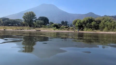 Reflection of Volcano San Pedro in lake Atitlan Stock Footage 329103741