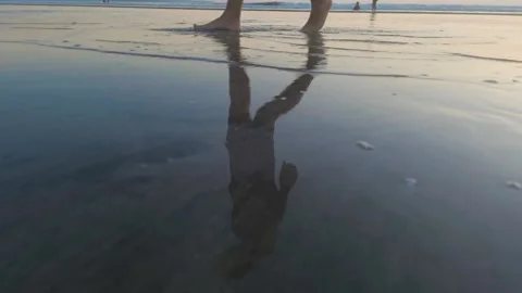 Reflection on walking man on beach in low tide Stock Footage 154423106