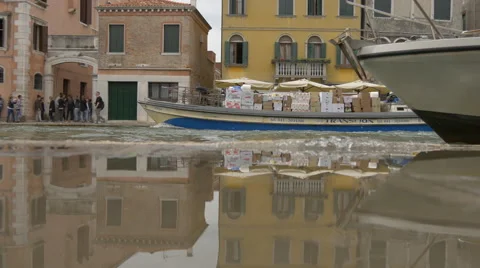Reflection in water of boats sailing through the canal in Venice Stock Footage 59851297