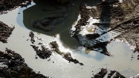 The reflection in water of an excavator working at a construction site Видео 88703287