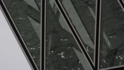 Reflection of water flowing in windows of the Port House in Antwerp (close-up) Stock Footage 113562717