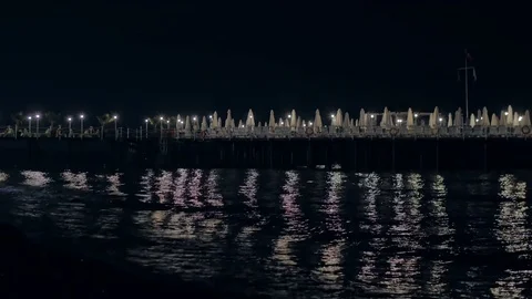 Reflection in the water of lights. Beautiful night landscape and pier. The Stock Footage 82457169