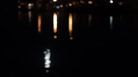 Reflection in water at night in a seaport in bokeh Video stock 128448604