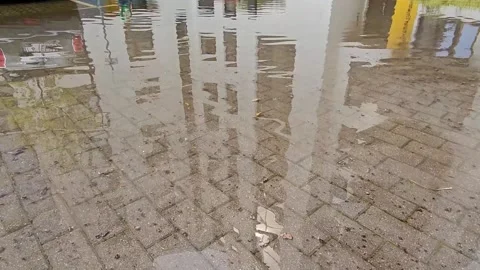 Reflection of water in the Puddle. The surroundings of the city. Summer day Stock Footage 248969451