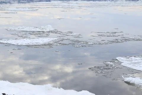 The reflection of water on a river in winter with icebergs Stock Photos