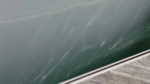 REFLECTION OF WATER ON SIDE OF YACHT Stock Footage 141743792