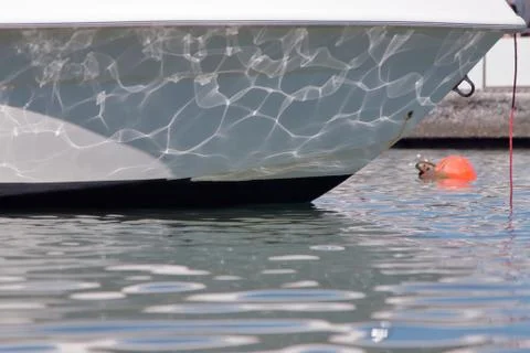 Reflection of the waves on the hull of a boat Stock Photos