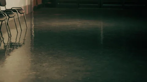 Reflection on wet floor in empty indoor space with chairs Stock Footage 342037278