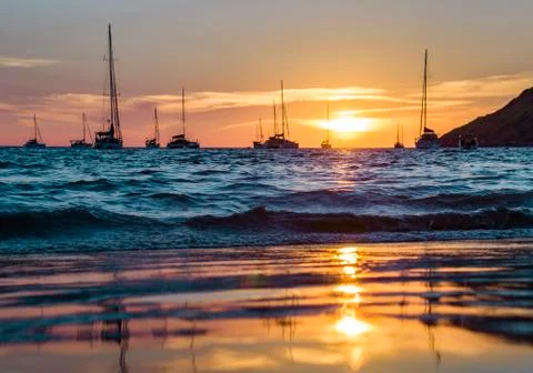 Reflection in the wet sand of an orange sunset on a background Foto stock