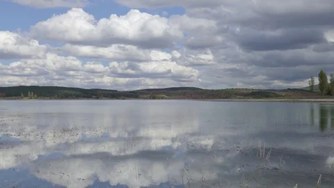 Reflection of white clouds in mountain lake Stock Footage 80995993