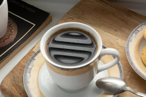 Reflection of a window and a drop of rain in a cup of coffee Stock Photos