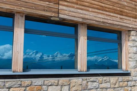 Reflection in the window of the Swiss Alps Stock Photos