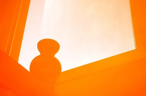Reflection of windows and vases on the windowsill in orange Stock Photos
