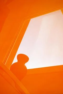 Reflection of windows and vases on the windowsill in orange Stock Photos