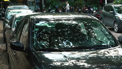 Reflection on the windshield of the black car. car parking trees reflection. Stock Footage 171400124