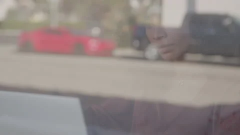 Reflection of a Woman in a Window as She Works Remotely in a Coffee Shop Stock Footage 222007252