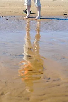 Reflection of a woman's torso on Charrua beach in Juan Lacaze, Colonia, Urugu Stock-Fotos
