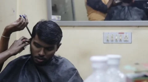 Reflection of young indian boy getting haircut Stock Footage 60001489