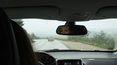Reflection of young woman's face in rearview car mirror. Stock Footage 244833579