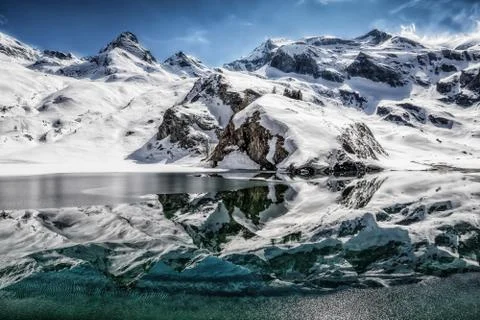 Reflections on an alpine lake Stock Photos