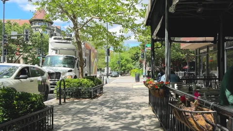 Reflections and sidewalk dining on Q Street NW in Washington D.C. Stock Footage 323567733