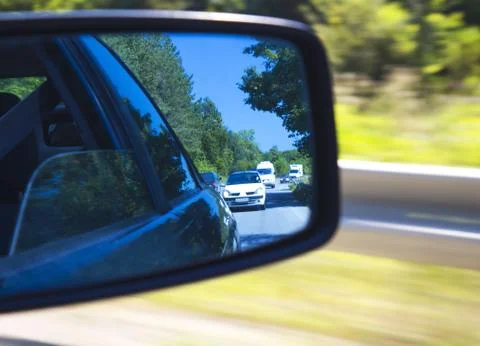 Reflections in the car mirror Stock Photos