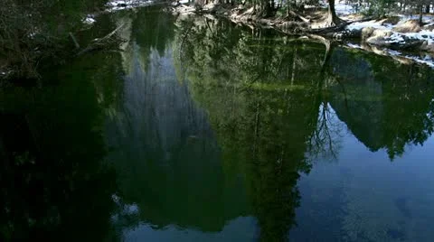 Reflections of Cathedral Rocks in Merced River at Yosemite Park Stock Footage 21428279