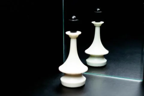Reflections of chess pieces in the mirror Stock Photos