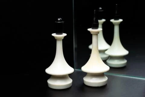Reflections of chess pieces in the mirror Stock Photos