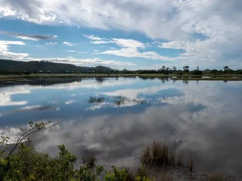 Reflections of clouds on water. Stock Photos