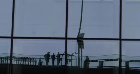 Reflections of commuters in glass facade grid, minimalist urban motion Stock Footage 320029685