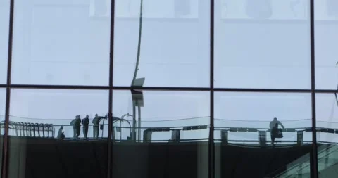 Reflections of commuters in glass facade grid, minimalist urban motion Stock Footage 320029687