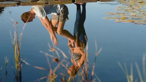 Reflections of couple doing acroyoga Stock Footage 76521594