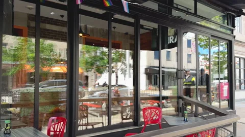 Reflections on glass storefront of modern café Stock Footage 323604612